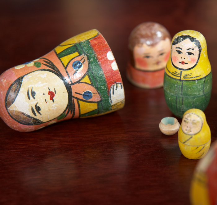 Family of russian dolls broken open to reveal smaller dolls