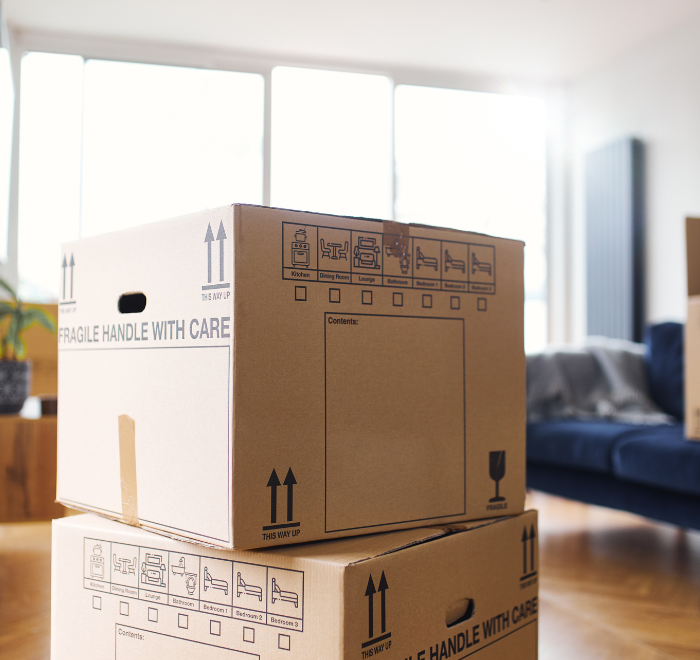 Image of moving boxes stacked up in a flat - moving out deposit return